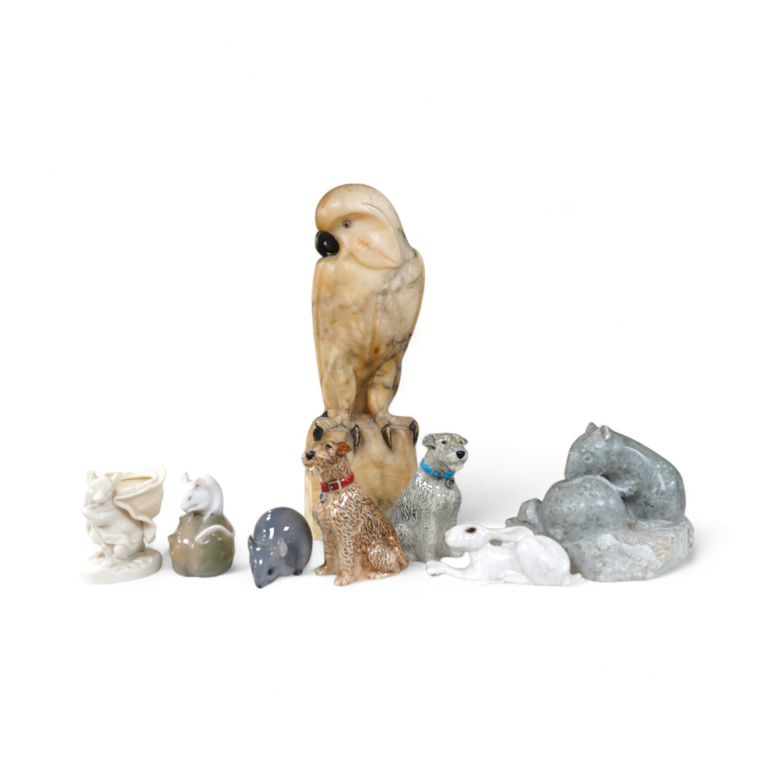 A carved alabaster parrot, a stone carving of two mice, two Royal Copenhagen mice, a mouse spill vase, a pair of dog pepperettes and a hare ornament, tallest 26cm high (8). Condition - small chip to ear of white Copenhag